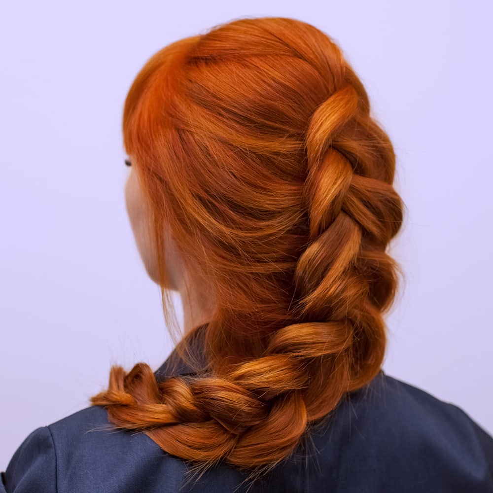 Back of head of woman with red hair after treatment with hair bond protector