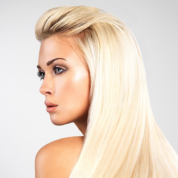 Woman with long blonde hair demonstrating plex product treatment